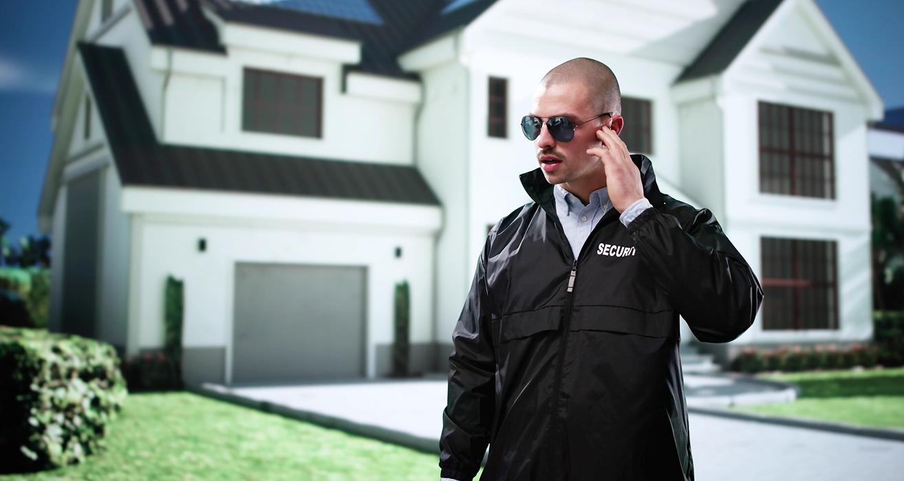 Security guard standing in front of house.