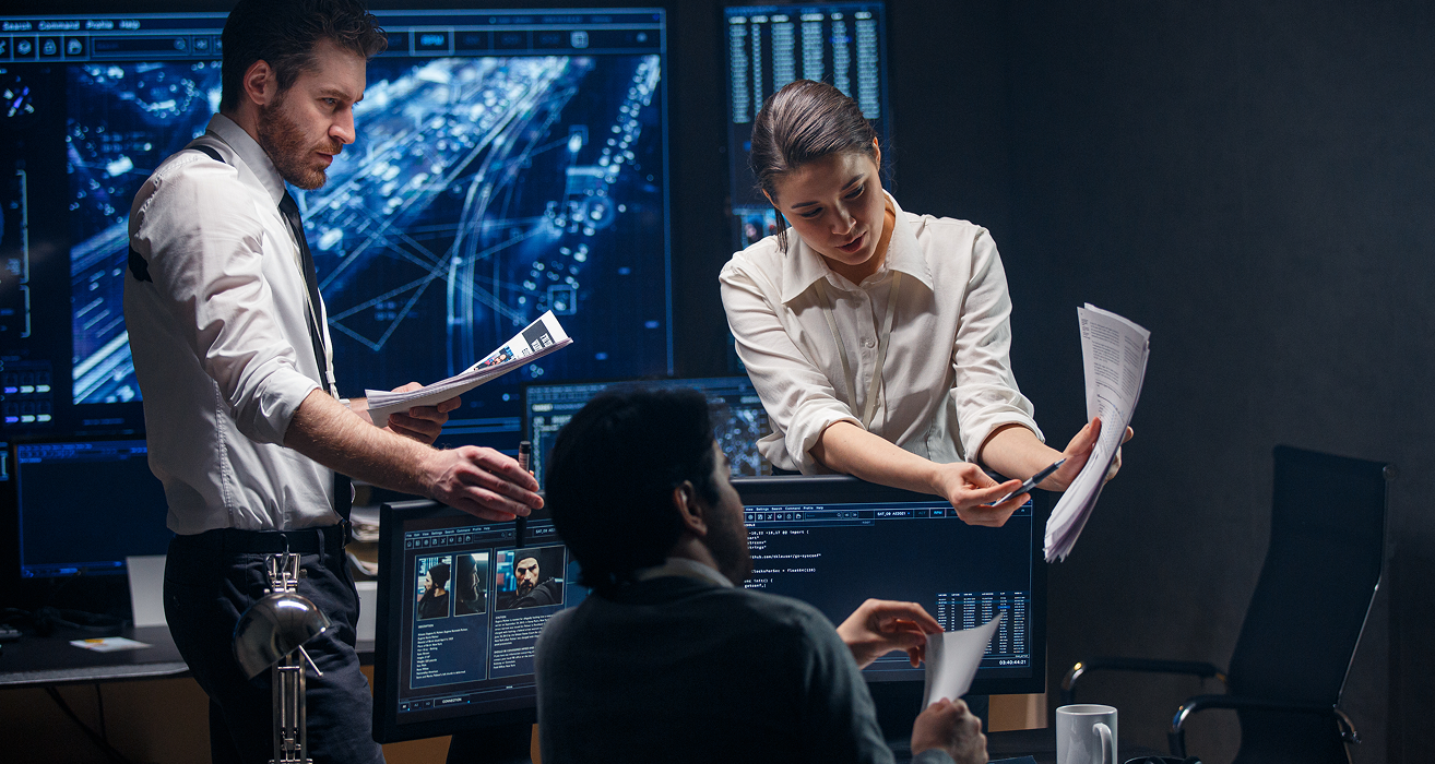 Team analyzing data in a control room.