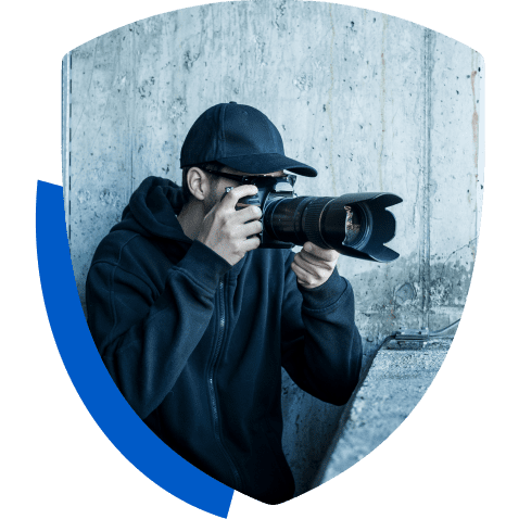 Photographer in dark clothing with camera.
